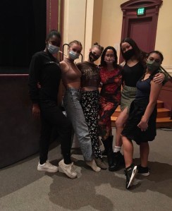 Left to Right: BFA sophomores Rilei Beene, Ella Can, Brooke Sinton, Rita Scott (GYROTONIC® instructor), Christina Van Duek, and Amanda Harris, standing together arm and arm at Angelico Concert Hall at Dominican University of California post-performance