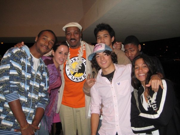 Left to right: Babatunji, Nadia Schlosser, Alonzo King, Norman Hakkei, Grady Sullivan, Trey Saunders, and Rebecca Delimont stand together with arms around each others' shoulders smiling