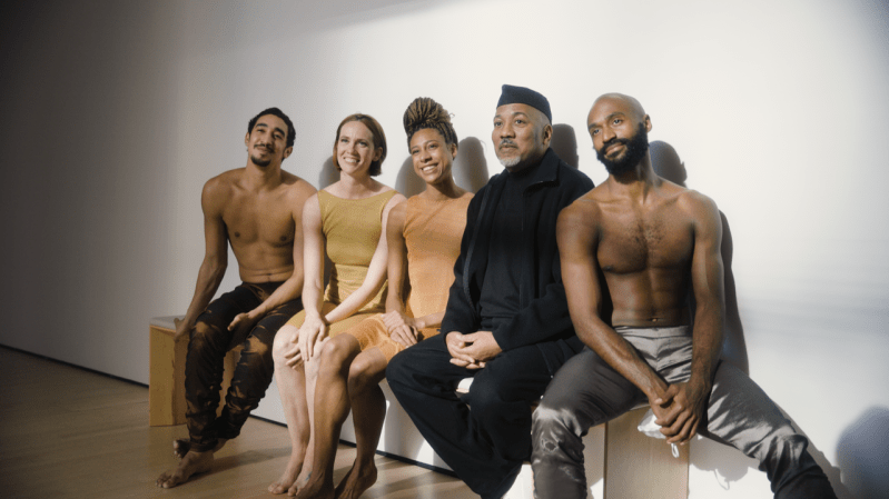 (From left to right) Shuaib Elhassan, Madeline DeVries, Adji Cissoko, Alonzo King, and Babatunji sitting together on a bench indoors