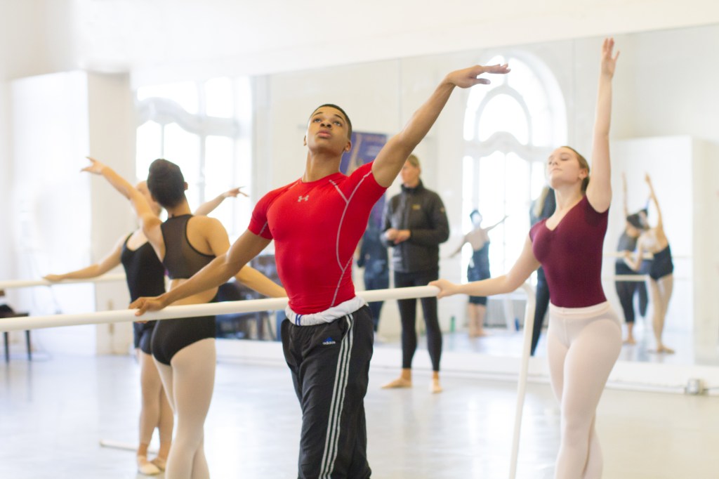 Summer Program dancers reach high in fifth position at the barre at LINES Dance Center.
