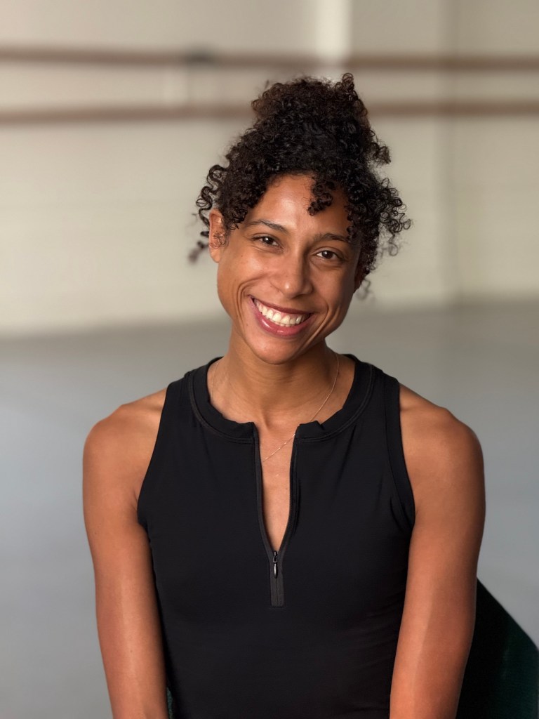 Adji CIssoko headshot, smiling in a studio at LINES Dance Center.